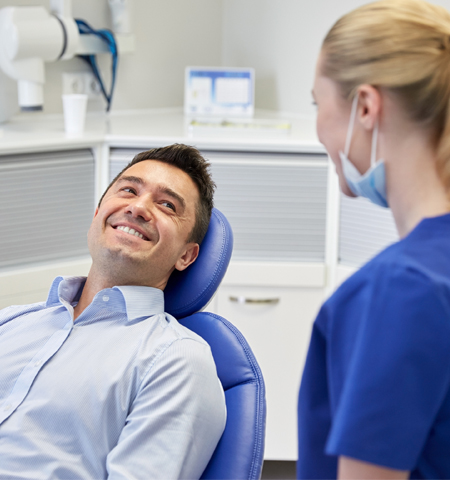 Man and Dental Hygienist Laughing in Raleigh, NC 