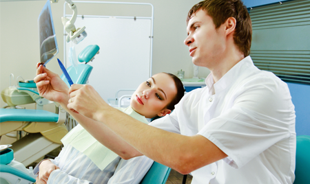 Dentist Showing an X-Ray to a Woman in Raleigh, NC 