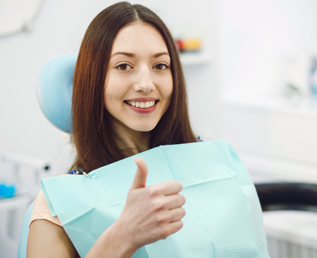 Smiling Woman Sitting in a Dentist Office in Raleigh, NC 