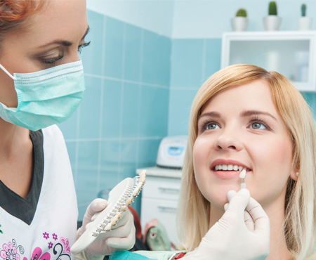 Woman Having Her Tooth Color Matched for a Crown in Raleigh, NC 