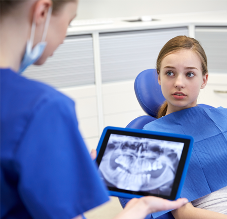 Dental Hygienist Talking to a Young Girl in Raleigh, NC 